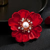 The Carmine Enamel Poppy Brooch - A vibrant, bright red round poppy brooch with sparkling crystals and a pearl in the centre.