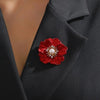 The Carmine Enamel Poppy Brooch - A vibrant, bright red round poppy brooch with sparkling crystals and a pearl in the centre.