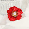 The Carmine Enamel Poppy Brooch - A vibrant, bright red round poppy brooch with sparkling crystals and a pearl in the centre.