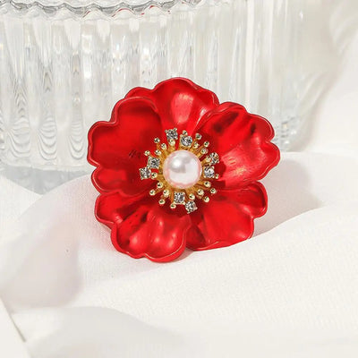 The Carmine Enamel Poppy Brooch - A vibrant, bright red round poppy brooch with sparkling crystals and a pearl in the centre.