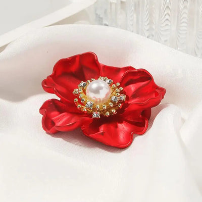 The Carmine Enamel Poppy Brooch - A vibrant, bright red round poppy brooch with sparkling crystals and a pearl in the centre.