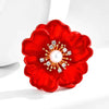 The Carmine Enamel Poppy Brooch - A vibrant, bright red round poppy brooch with sparkling crystals and a pearl in the centre.