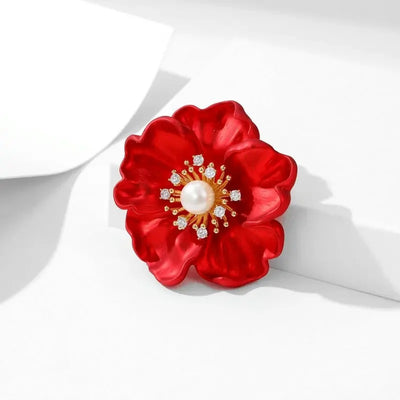 The Carmine Enamel Poppy Brooch - A vibrant, bright red round poppy brooch with sparkling crystals and a pearl in the centre.