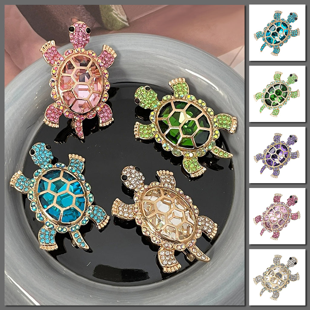 Caspia Crystal Turtle Brooch - A large stylised turtle brooch, composed of a single large, oval-shaped crystal encased in a shell of golden-coloured metal, and surrounded by lots of tiny matching crystals.