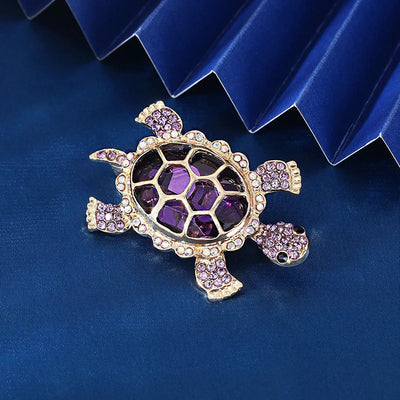 Caspia Crystal Turtle Brooch - A large stylised turtle brooch, composed of a single large, oval-shaped crystal encased in a shell of golden-coloured metal, and surrounded by lots of tiny matching crystals.