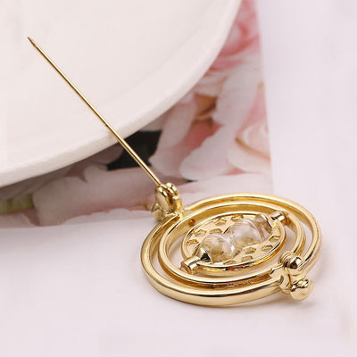 Cheeky Geek Time Turner Brooch - A small golden brooch with an hourglass in the centre, inspired by the Time Turner magical device from the Harry Potter series.