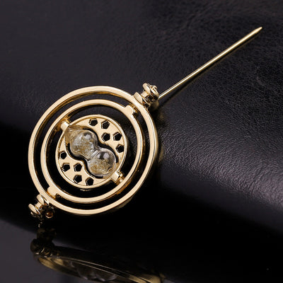 Cheeky Geek Time Turner Brooch - A small golden brooch with an hourglass in the centre, inspired by the Time Turner magical device from the Harry Potter series.