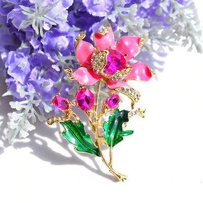 Citrika Orange Blossom Brooch - A detailed floral brooch featuring a large central stone with ruffled enamel petals surrounding it, and lots of colourful crystals to really make it pop.