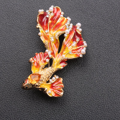 Cleo Double Tail Betta Fish Brooch - Three elegant stylised fish brooches adorned with tiny crystals and pearls, available in blue, orange, or purple colour palettes.