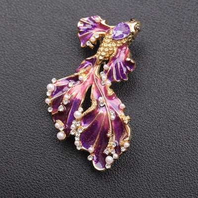 Cleo Double Tail Betta Fish Brooch - Three elegant stylised fish brooches adorned with tiny crystals and pearls, available in blue, orange, or purple colour palettes.