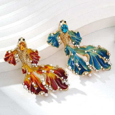 Cleo Double Tail Betta Fish Brooch - Three elegant stylised fish brooches adorned with tiny crystals and pearls, available in blue, orange, or purple colour palettes.