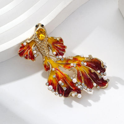 Cleo Double Tail Betta Fish Brooch - Three elegant stylised fish brooches adorned with tiny crystals and pearls, available in blue, orange, or purple colour palettes.