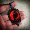 Crimson Corvid Cameo Necklace - A large gothic glass cabochon featuring an image of a black raven against a bright red background.