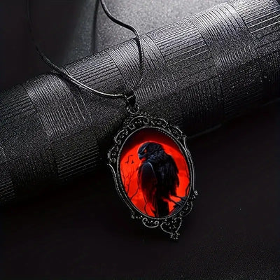 Crimson Corvid Cameo Necklace - A large gothic glass cabochon featuring an image of a black raven against a bright red background.