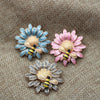 Cute Critters Brooch - Bumblebloom II - A 35mm round stylised flower brooch with a cute little bumble bee charm attached to it, available in pink, blue, or dark grey.