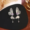 The Cynthia Butterfly Crystal Earrings - Sparkling silver butterfly wing earrings with purple and white crystals.