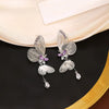 The Cynthia Butterfly Crystal Earrings - Sparkling silver butterfly wing earrings with purple and white crystals.