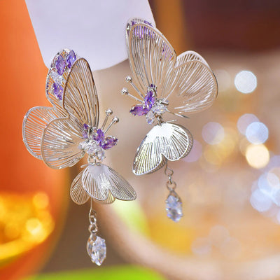 The Cynthia Butterfly Crystal Earrings - Sparkling silver butterfly wing earrings with purple and white crystals.