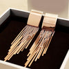 Dakari Tassel Earrings - Long stylish statement dangle earrings, featuring a solid rectangle over the lobe, with assorted long tassels strung off it.