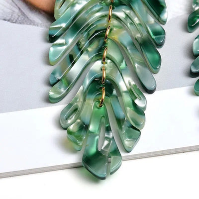 Daphne Acrylic Fern Frond Dangle Earrings - Large resin earrings made to resemble the fronds of a fern, formed from marbled acrylic in various shades of green, red, cream, yellow, and purple.