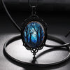 Dark Forest Cameo Necklace - A large gothic glass cabochon featuring an image of dark, spooky trees against a dark blue night sky background.