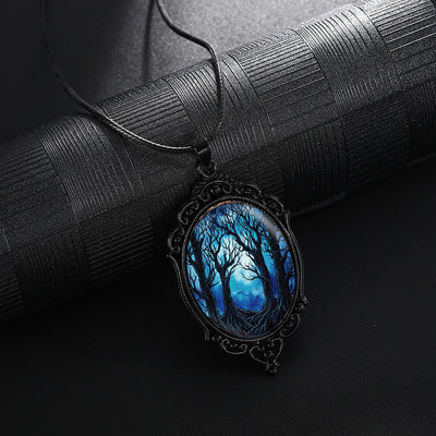 Dark Forest Cameo Necklace - A large gothic glass cabochon featuring an image of dark, spooky trees against a dark blue night sky background.