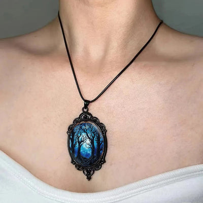 Dark Forest Cameo Necklace - A large gothic glass cabochon featuring an image of dark, spooky trees against a dark blue night sky background.