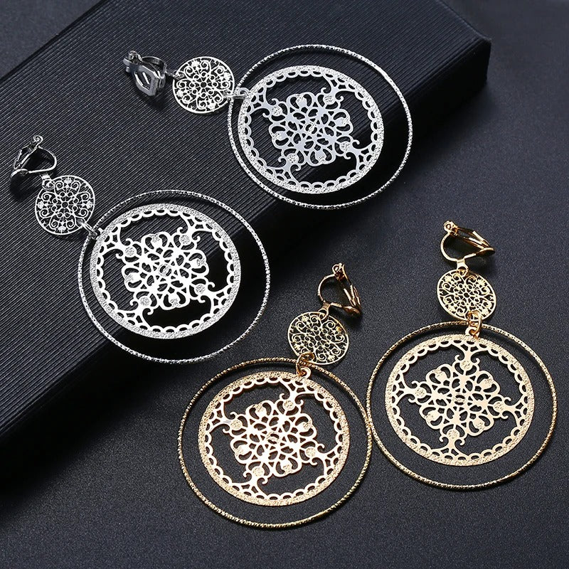 Devani Filigree Disc Clip Earrings - Metal clip-on earrings made from a series of interlocking metal circles, with an embossed filigree pattern.