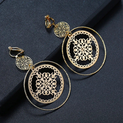 Devani Filigree Disc Clip Earrings - Metal clip-on earrings made from a series of interlocking metal circles, with an embossed filigree pattern.