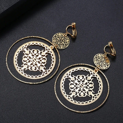 Devani Filigree Disc Clip Earrings - Metal clip-on earrings made from a series of interlocking metal circles, with an embossed filigree pattern.