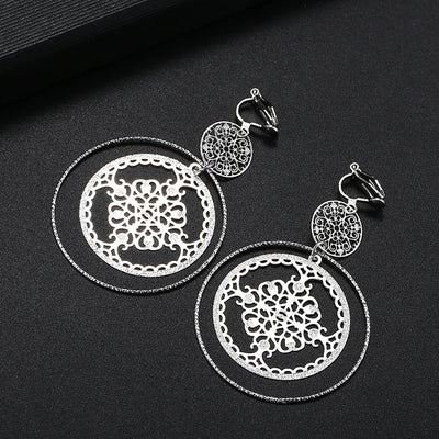 Devani Filigree Disc Clip Earrings - Metal clip-on earrings made from a series of interlocking metal circles, with an embossed filigree pattern.