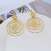 Devani Filigree Disc Clip Earrings - Metal clip-on earrings made from a series of interlocking metal circles, with an embossed filigree pattern.