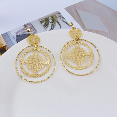 Devani Filigree Disc Clip Earrings - Metal clip-on earrings made from a series of interlocking metal circles, with an embossed filigree pattern.