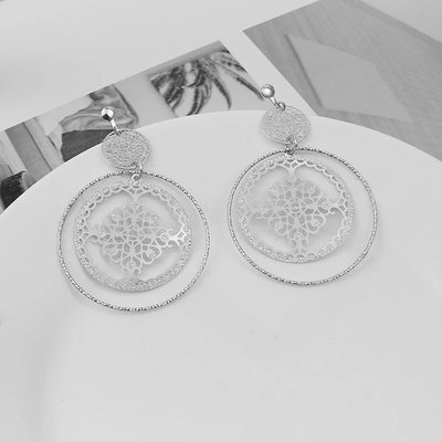 Devani Filigree Disc Clip Earrings - Metal clip-on earrings made from a series of interlocking metal circles, with an embossed filigree pattern.