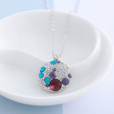 The Elemental Medallion - A small round pendant set with assorted white and coloured crystals on a standard link chain.