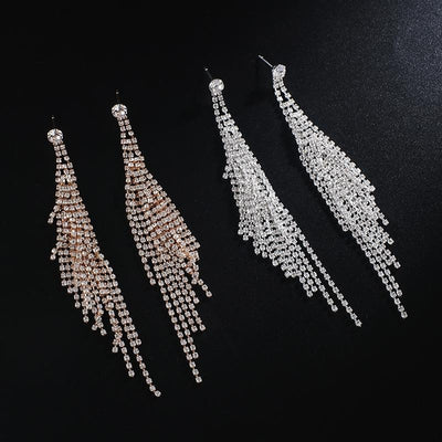 The Elisa Luxury Crystal Earrings are the perfect start to your luxurious collection. They feature a larger crystal at the lobe, attached to multiple long, cascading strands to dance around your shoulders.