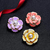 Emma II Ruffled Peony Enamel Brooch - A round, elegant brooch featuring an array of ruffled petals clustered around a small round pearl.