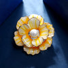Emma II Ruffled Peony Enamel Brooch - A round, elegant brooch featuring an array of ruffled petals clustered around a small round pearl.