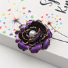 Emma Ruffled Peony Enamel Brooch - A round, elegant brooch featuring an array of ruffled petals clustered around a small round pearl.
