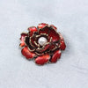 Emma Ruffled Peony Enamel Brooch - A round, elegant brooch featuring an array of ruffled petals clustered around a small round pearl.