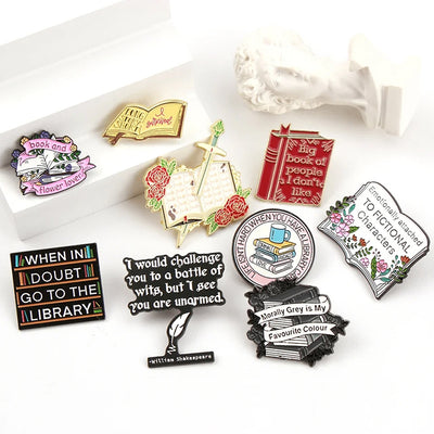 The "Book And Flower Lover" Enamel Pin is a tiny, but very stylish enamel pin, featuring a pile of stylised books wreathed in flowers and ribbons, along with simple letters proclaiming your love of said books and flowers. So cute! Grab yours today!