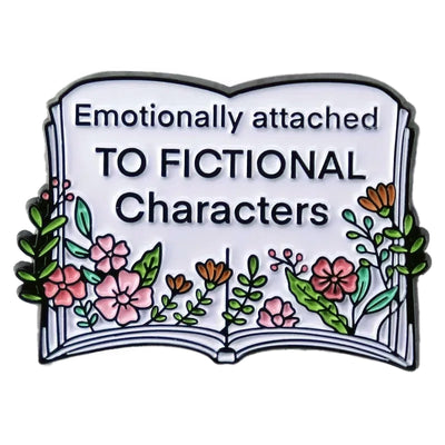 The "Emotionally Attached To Fictional Characters" Enamel Pin features a stylised book adorned with delicate leaves and flowers, and text proclaiming your love of certain fictional characters. Oh my! No judgement here!