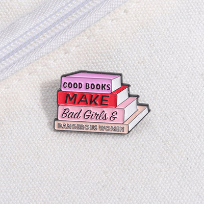 The "Good Books Make Bad Girls &amp; Dangerous Women" Enamel Pin is a small, stylish brooch featuring a stack of stylised books with text on the spines forming this very excellent and appropriate slogan. So true! Grab yours today!