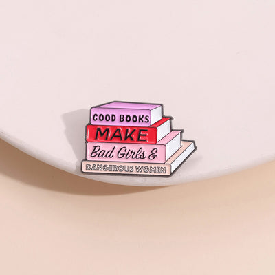 The "Good Books Make Bad Girls &amp; Dangerous Women" Enamel Pin is a small, stylish brooch featuring a stack of stylised books with text on the spines forming this very excellent and appropriate slogan. So true! Grab yours today!