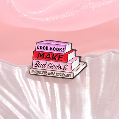 The "Good Books Make Bad Girls &amp; Dangerous Women" Enamel Pin is a small, stylish brooch featuring a stack of stylised books with text on the spines forming this very excellent and appropriate slogan. So true! Grab yours today!