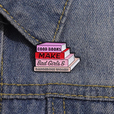 The "Good Books Make Bad Girls &amp; Dangerous Women" Enamel Pin is a small, stylish brooch featuring a stack of stylised books with text on the spines forming this very excellent and appropriate slogan. So true! Grab yours today!