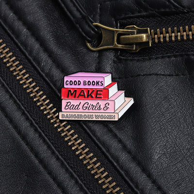 The "Good Books Make Bad Girls &amp; Dangerous Women" Enamel Pin is a small, stylish brooch featuring a stack of stylised books with text on the spines forming this very excellent and appropriate slogan. So true! Grab yours today!