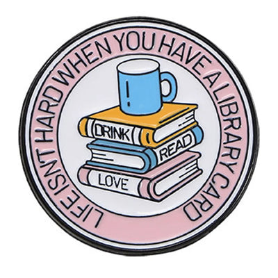 The "Life Isn't Hard When You Have A Library Card" Enamel Pin features a stack of books in the centre (plus a cup of sweet, sweet coffee!), within a ring of text proclaiming your love for libraries.
