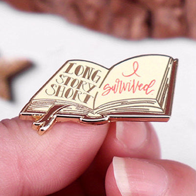 The "Long Story Short, I Survived" Enamel Pin is a small, stylish brooch featuring a stylised book with the text "Long Story Short, I Survived". Make of that what you will! Grab yours today!