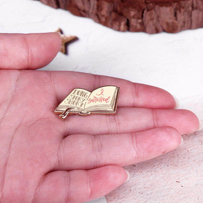 The "Long Story Short, I Survived" Enamel Pin is a small, stylish brooch featuring a stylised book with the text "Long Story Short, I Survived". Make of that what you will! Grab yours today!